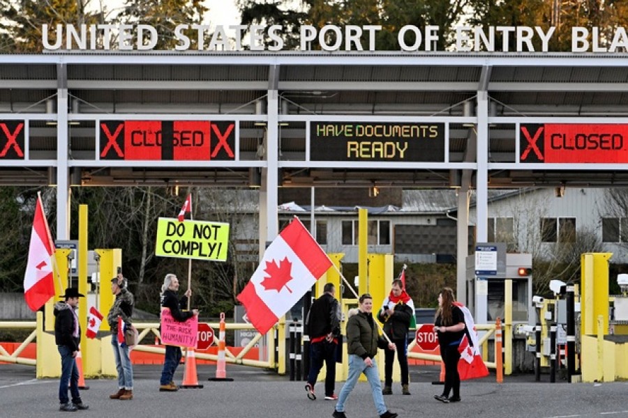 A convoy of truckers and supporters continue to protest coronavirus disease (COVID-19) vaccine mandates at a closed border on Pacific highway, near the border in Surrey, British Columbia, Canada, February 12, 2022 – Reuters/Jennifer Gauthier