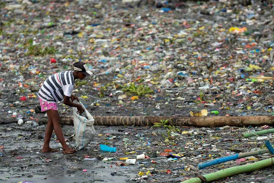 A woman picking up plastic cups along the riverbank of Pasig river in Manila of Philippines on June 10 last year –Reuters file photo