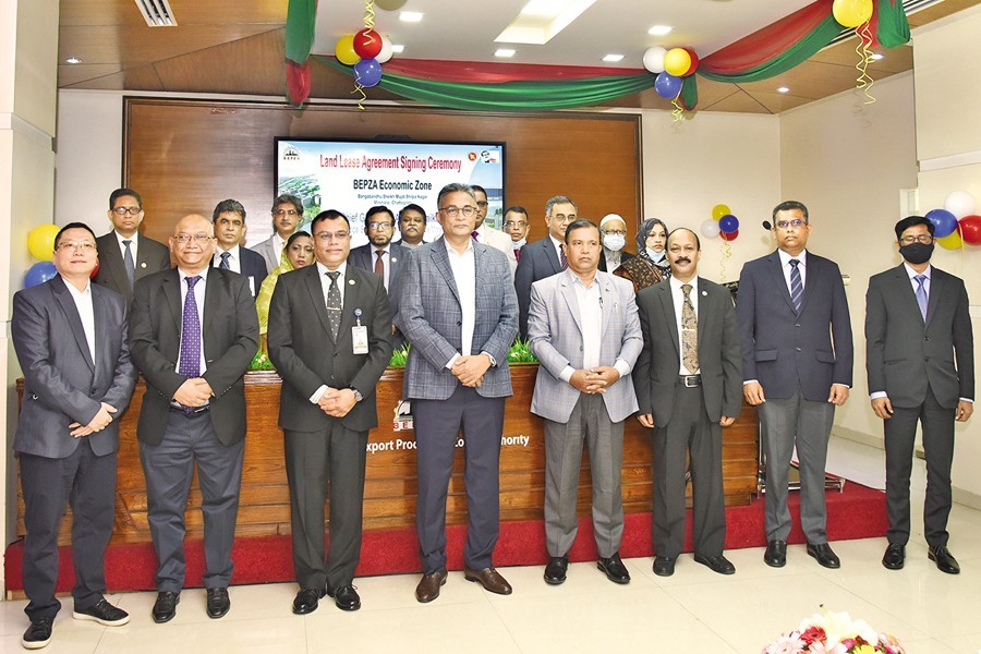 The Prime Minister's Principal Secretary Dr Ahmad Kaikaus, BEPZA Executive Chairman Maj Gen Abul Kalam Mohammad Ziaur Rahman, Executive Chairman of Bangladesh Economic Zones Authority Shaikh Yusuf Harun, BEPZA Member (Investment Promotion) Ali Reza Mazid, President of Bangladesh EPZs Investors' Association S M Khan and other officials pose for photo after the signing of land lease agreements between BEPZA and four companies at the BEPZA Complex in Dhaka on Saturday