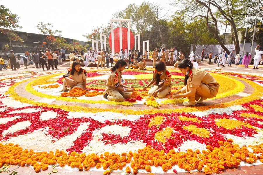 Volunteers arrange the decoration in front of the language martyrs' memorial monument in Dhaka, Bangladesh, Feb. 21, 2021.	—Xinhua Photo