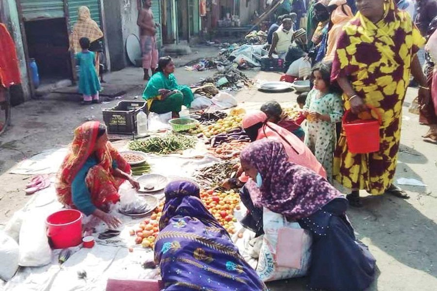 Poor female traders busy selling vegetables in Bou Bazaar at Puranbazar in Chandpur town — FE Photo