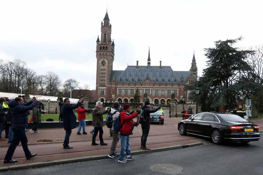 People taking pictures as cars arrive at the International Court of Justice (ICJ) in The Hague of Netherlands on December 12 in 2019 during hearings in a case filed by Gambia against Myanmar alleging genocide against the minority Muslim Rohingya population –Reuters file photo