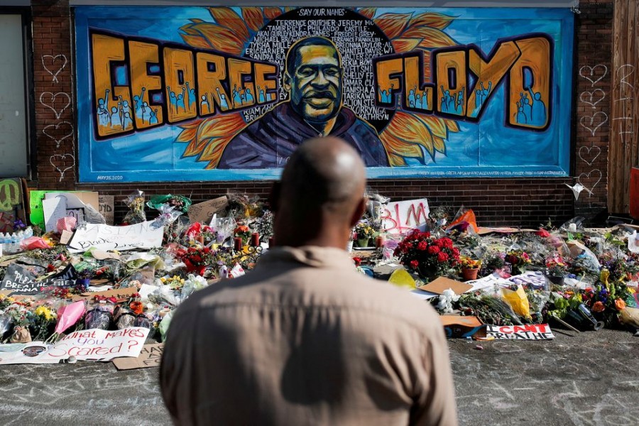 A local resident stands in front of a makeshift memorial honoring George Floyd, at the spot where he was taken into custody, in Minneapolis, Minnesota, US, June 1, 2020 – Reuters/Carlos Barria/File Photo