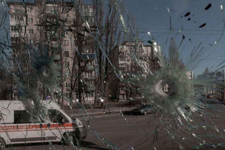 An ambulance is seen through the damaged window of a vehicle hit by bullets, as Russia's invasion of Ukraine continues, in Kyiv of Ukraine on Monday –Reuters photo