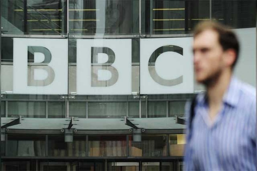 A pedestrian walks past a BBC logo at Broadcasting House in central London October 22, 2012. Reuters