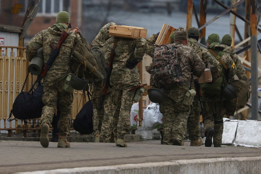 Ukrainian military members walk following the ongoing Russian invasion in Lviv, Ukraine, March 5, 2022. REUTERS/Kai Pfaffenbach