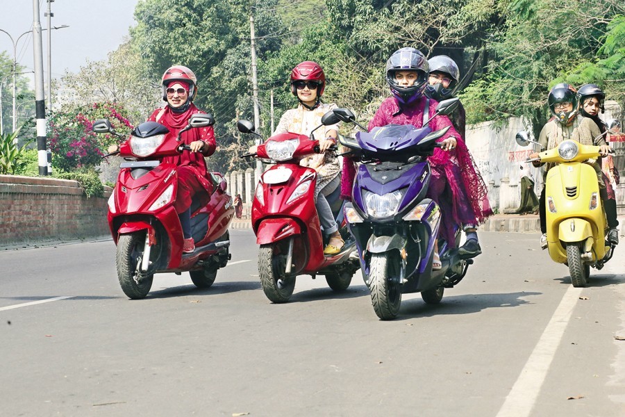 Women bikers under the banner of 'Women's scooter School Bd' are out to enjoy a pleasure ride on the Dhaka University campus on Tuesday as they gathered there on the occasion of International Women's Day — FE photo by KAZ Sumon