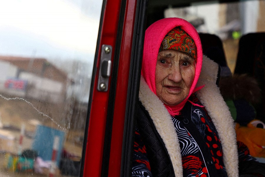 Natasha, 83 years old, who witnessed World War Two, looks out of a shuttle bus after crossing the border from Ukraine to Poland after fleeing from Mykolajiw following the Russian invasion of Ukraine, at the border checkpoint in Medyka, Poland on March 8, 2022 — Reuters photo