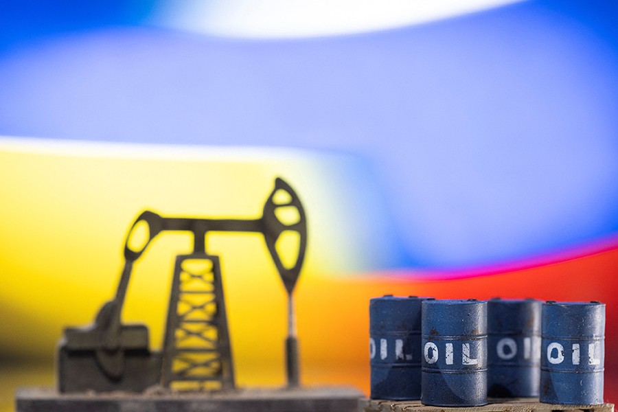 Models of oil barrels and a pump jack are displayed in front of Ukrainian and Russian flag colors in this illustration taken on February 24, 2022 — Reuters/Files