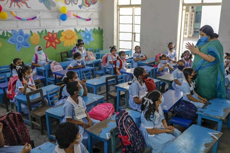 Teachers instructing students on health rules at Viqarunnisa Noon School and College in Dhaka after the resumption of in-person classes amid the coronavirus pandemic on September 12 last year  –bdnews24.com file photo