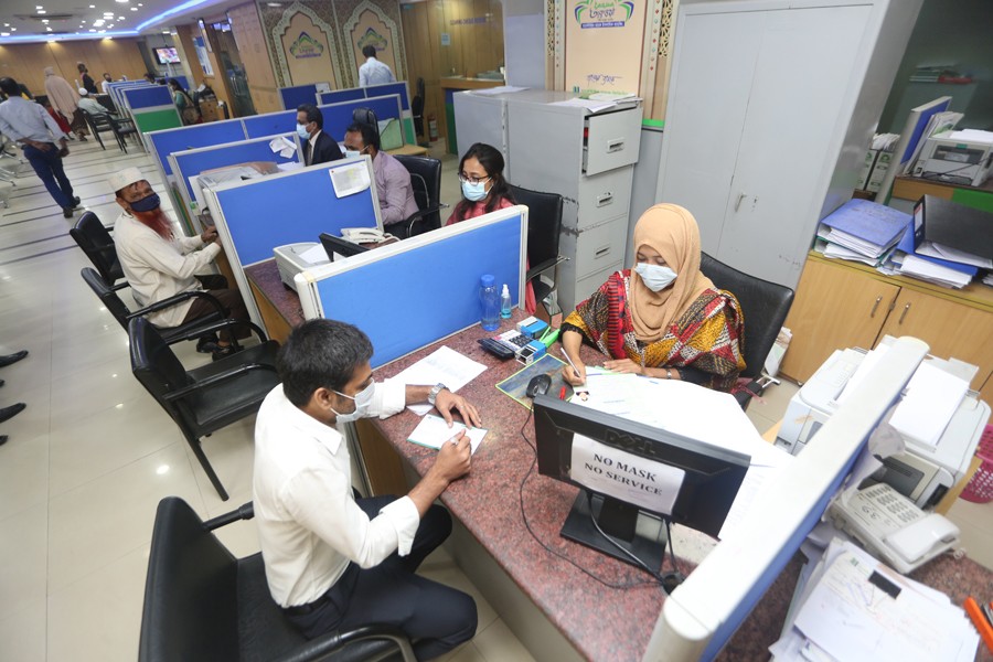 Officials are seen at a bank in Dhaka. Banks are entirely dependent on SWIFT to settle any international transactions. 	 —FE Photo