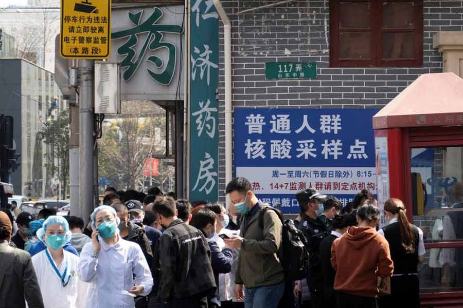 Residents lining up outside a nucleic acid testing site of a hospital in Shanghai of China on Friday -Reuters photo