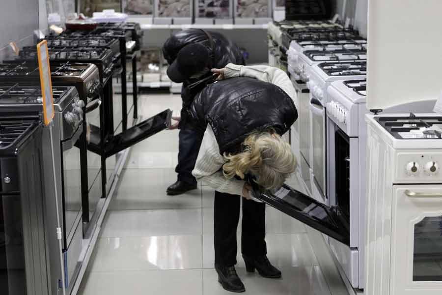 Customers inspecting kitchen stoves at an electronic store in Stavropol in southern Russia -Reuters file photo