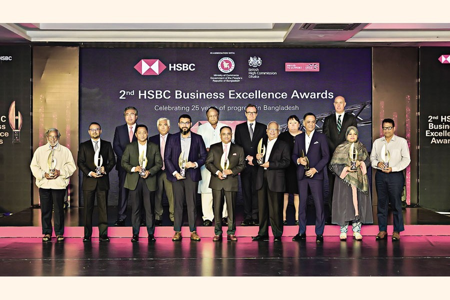 Recipients of the '2nd HSBC Business Excellence Awards' pose for a photograph with the guests, including Commerce Minister Tipu Munshi and British High Commissioner to Bangladesh Robert Chatterton Dickson, at a programme in the city on Sunday