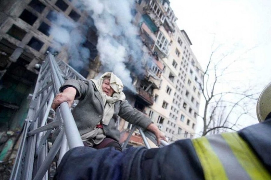Rescuers work to get a woman out of a residential building that was struck, as Russia's attack on Ukraine continues, in Kyiv, Ukraine, in this handout picture released Mar 14, 2022. Press service of the State Emergency Service of Ukraine