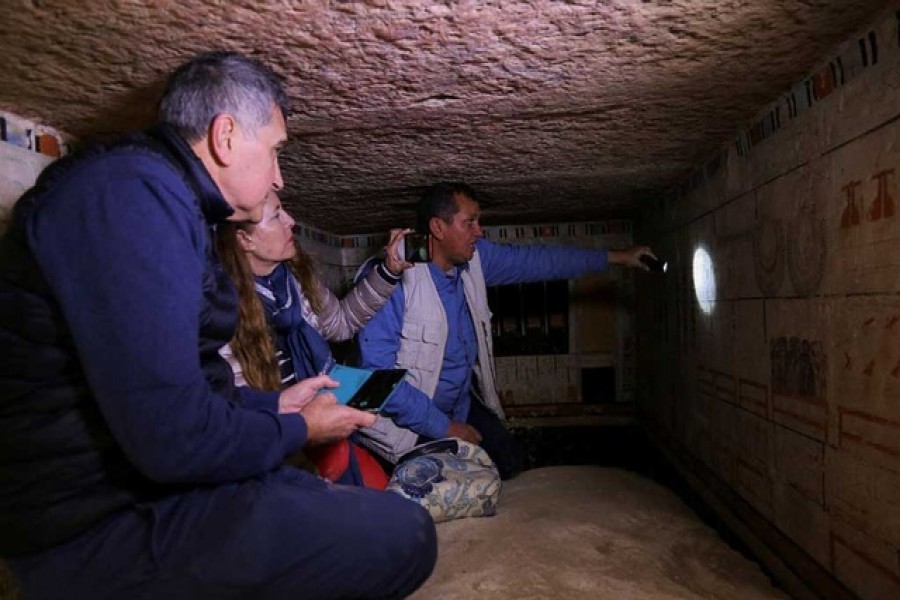 Egyptian archaeologist speaks inside the tomb of a woman named Petty who was responsible for the King's beautification and the priest of Hathor, at a recently discovered tomb at the Saqqara area, in Giza, Egypt, March 19, 2022. REUTERS/Hanaa Habib