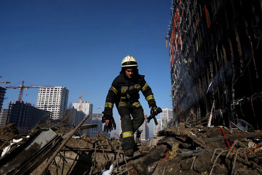 A rescuer walks through debris at the site of a bombing at a shopping centre as Russia's invasion of Ukraine continues, in Kyiv, Ukraine on March 21, 2022 — Reuters photo