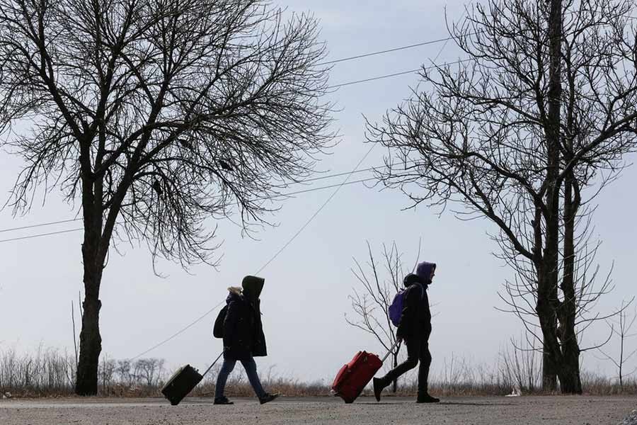 Refugees walking along a road as they leave the city during Ukraine-Russia conflict in the besieged southern port of Mariupol of Ukraine on March 20 this year –Reuters file photo