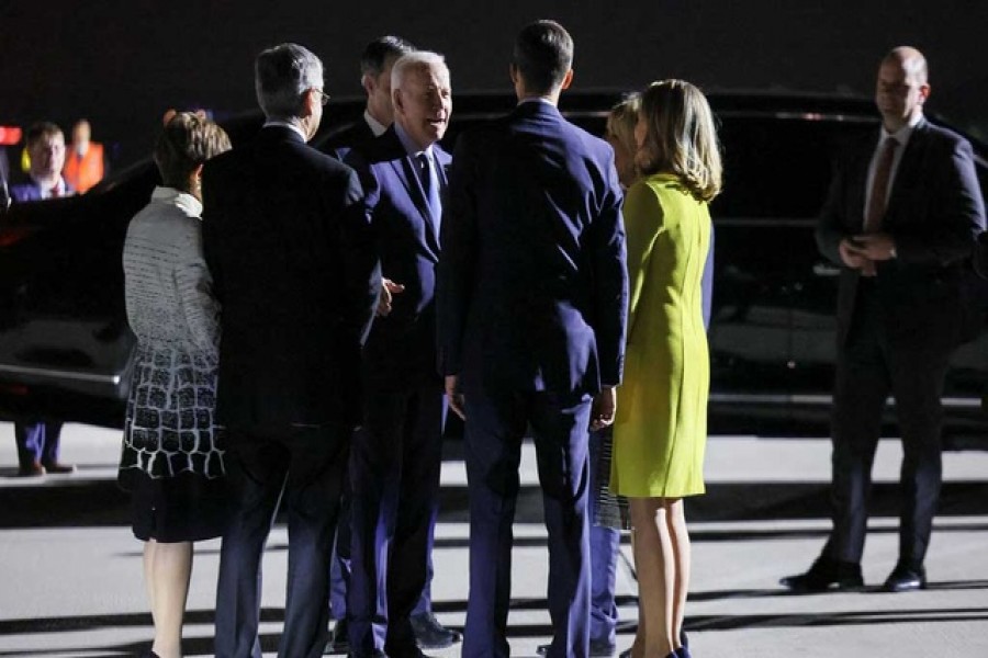 A Belgian delegation welcomes US President Joe Biden, who arrives to attend an extraordinary NATO summit to discuss ongoing deterrence and defence efforts in response to Russia's attack on Ukraine, in Brussels, Belgium, March 23, 2022. REUTERS