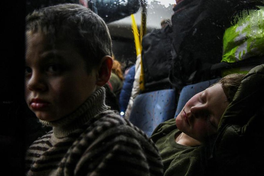 Children rest inside an evacuee bus after they fled from Mariupol, amid Russia's invasion of Ukraine, in Zaporizhzhia, Ukraine on March 22, 2022 — Reuters photo