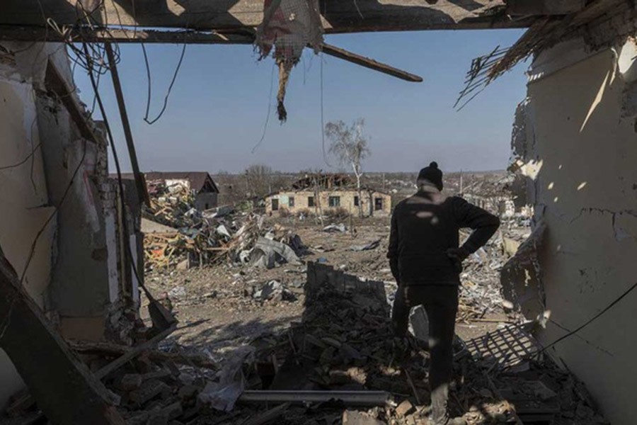 A local man looks on from the cultural centre destroyed in shelling earlier this month, as Russia's invasion of Ukraine continues, in the village of Byshiv outside Kyiv, Ukraine, Mar 24, 2022. Reuters