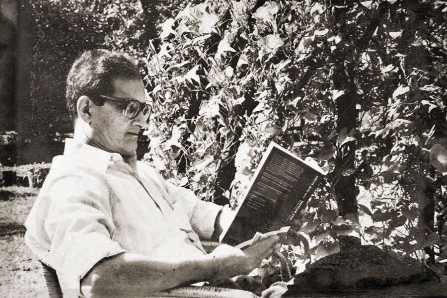 Amartya Sen reading in the garden of Santiniketan, 1964