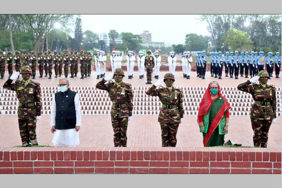 President M Abdul Hamid and Prime Minister Sheikh Hasina stand in solemn silence for some time at the National Memorial in Savar on Saturday as a mark of profound respect to the memories of the martyrs of the Great War of Liberation in 1971