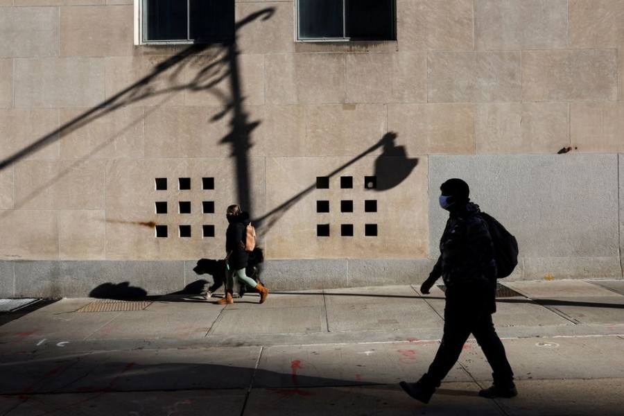 People wearing protective face masks, amid the coronavirus disease (Covid-19) pandemic, walk in the Manhattan borough of New York City, US on February 10, 2022 — Reuters/Files