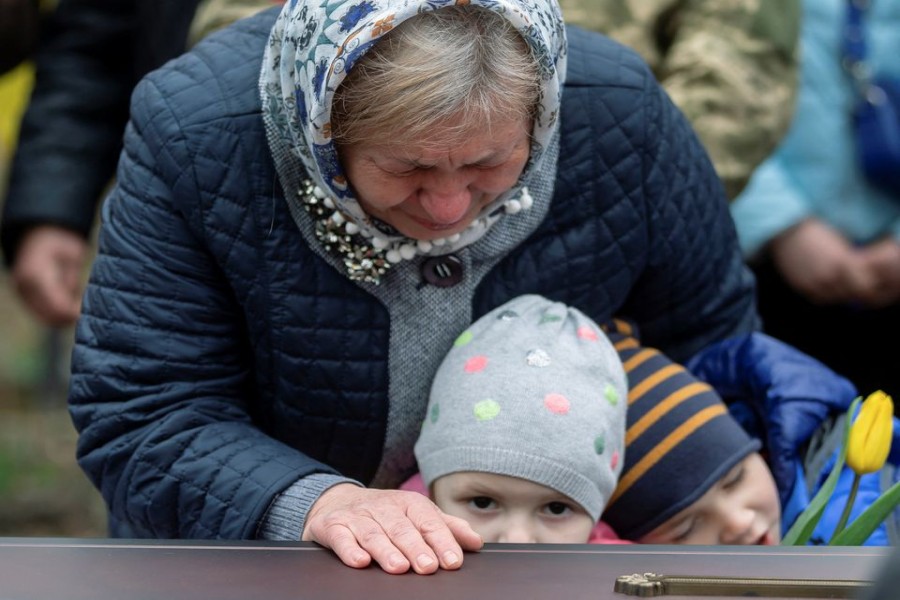 Maria, wife of a Ukrainian soldier Vasyl Vekliuk, 59, who died in a shelling near Popasna in the Luhansk region, amid Russia's invasion of Ukraine, attends his funeral in Stebnyk, Lviv region, Ukraine, March 30, 2022. REUTERS/Viacheslav Ratynskyi