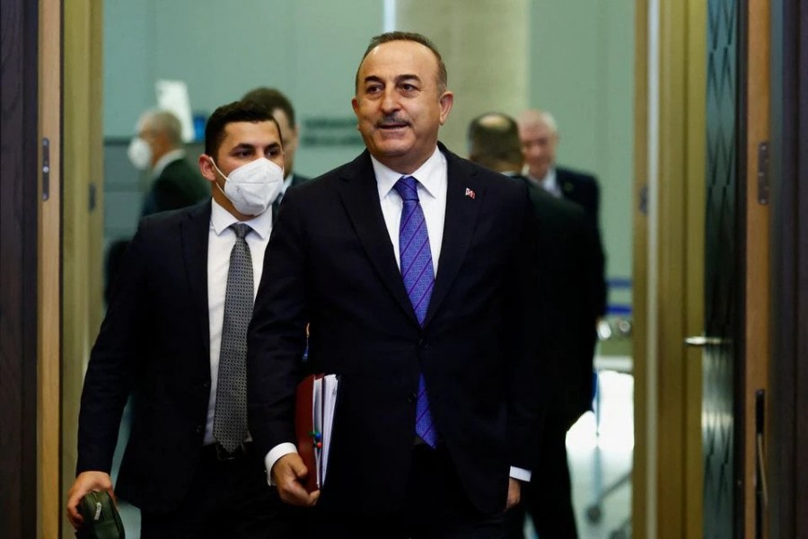Turkish Foreign Minister Mevlut Cavusoglu walks in to attend a NATO summit to discuss Russia's invasion of Ukraine, at the alliance's headquarters in Brussels, Belgium, March 24, 2022. REUTERS/Gonzalo Fuentes
