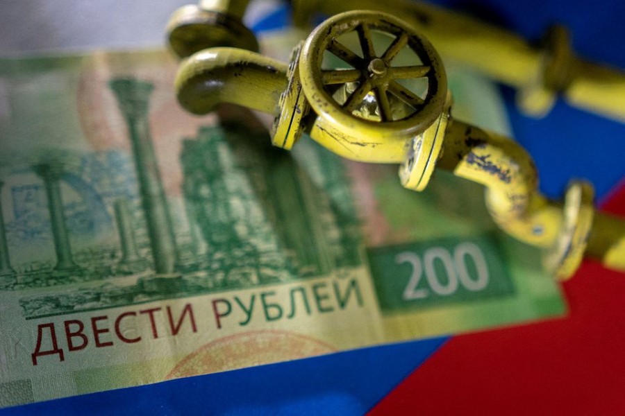 A model of the natural gas pipeline is placed on Russian rouble banknote and a flag in this illustration taken, March 23, 2022. REUTERS//File Photo