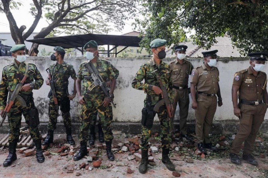 Sri Lankan Special Task Force and Police officers stand guard at the top of the road to Sri Lankan President Gotabaya Rajapaksa's residence, after police officers and demonstrators clashed at a protest against him, as many parts of the crisis-hit country faced up to 13 hours without electricity due to a shortage of foreign currency to import fuel, in Colombo, Sri Lanka April 1, 2022. Reuters