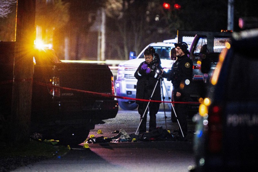 Representative Image: Police officers view the crime scene, where according to the Portland Police Bureau one person was shot dead and five others were wounded, at Normandale Park in Portland, Oregon, US February 19, 2022. Reuters