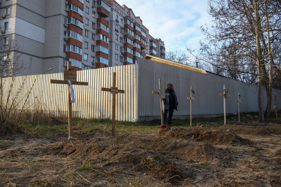 A man stands next to graves with bodies of civilians, who according to local residents were killed by Russian soldiers, as Russia's attack on Ukraine continues, in Bucha, in Kyiv region, Ukraine on April 4, 2022 — Reuters photo