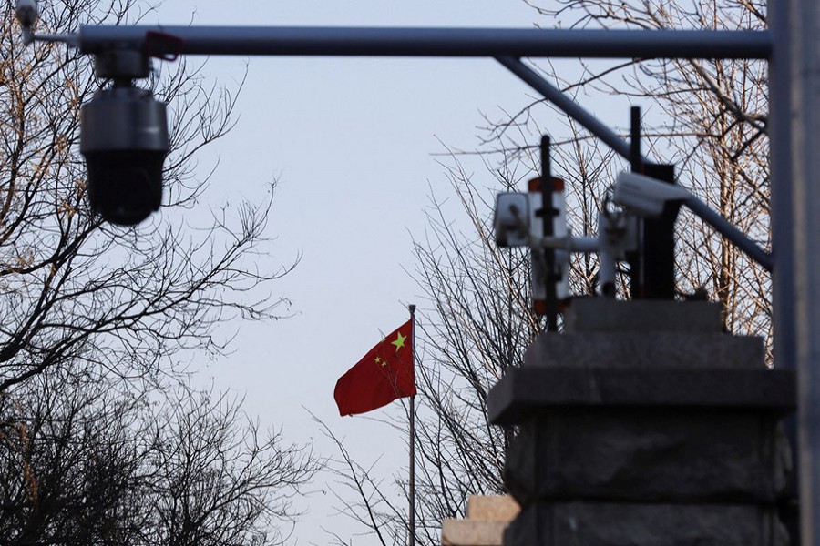 A Chinese flag is seen near surveillance cameras outside the Beijing No. 2 Intermediate People's Court, where Australian journalist Cheng Lei is expected to face trial on state secrets charges, in Beijing, China on March 31, 2022 — Reuters photo