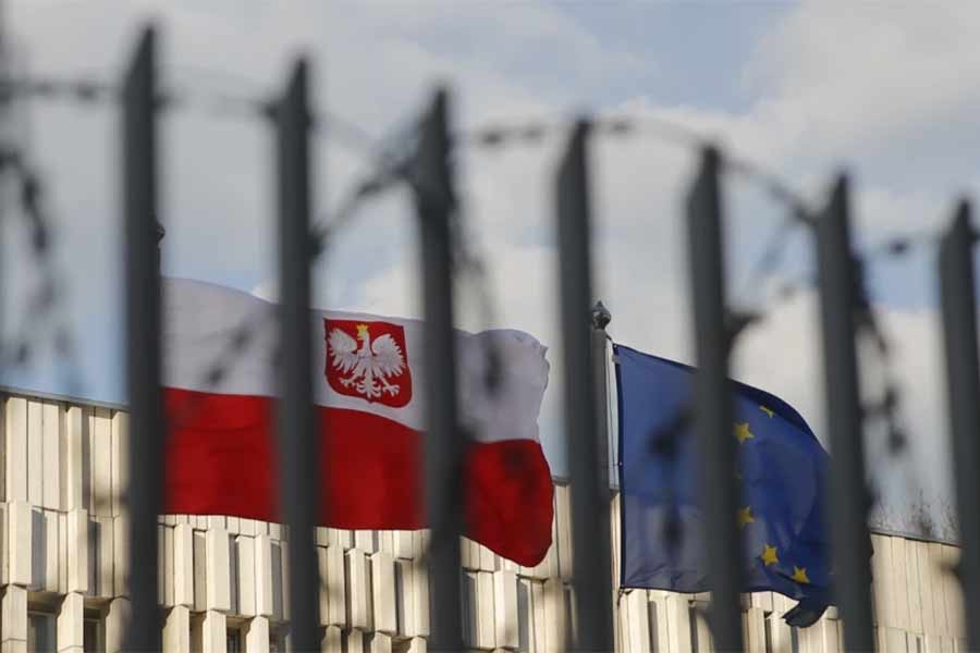 A view through a fence shows flags of Poland and the European Union outside the Polish embassy in Moscow –Reuters file photo