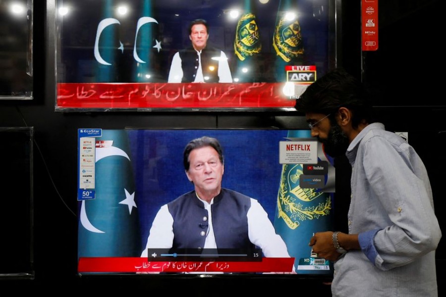 A shopkeeper tunes a television screen to watch the speech of Pakistani Prime Minister Imran Khan, at his shop in Islamabad, Pakistan, March 31, 2022 – Reuters/Akhtar Soomro