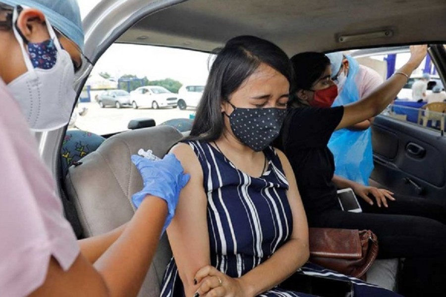 A woman receives a dose of COVISHIELD, a coronavirus disease vaccine manufactured by India’s Serum Institute. Reuters