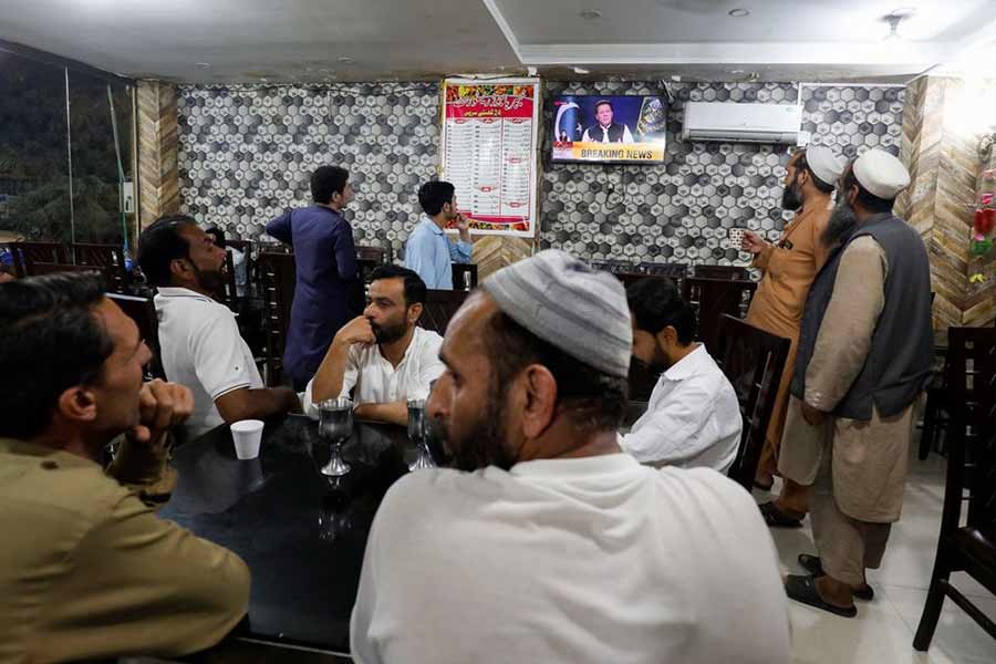 People watching the speech of Pakistani Prime Minister Imran Khan on a television screen, at a cafe in Islamabad on Friday –Reuters file photo