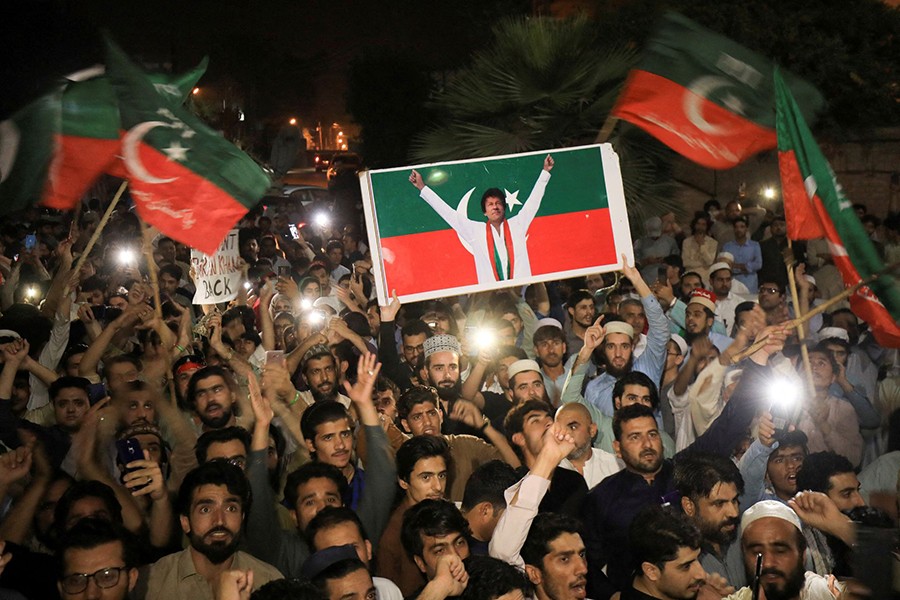 Supporters of the Pakistan Tehreek-e-Insaf (PTI) political party wave flags and chant in support of former Pakistani Prime Minister Imran Khan, after he lost a confidence vote in the lower house of parliament, during a rally in Peshawar on Pakistan April 10, 2022 — Reuters photo