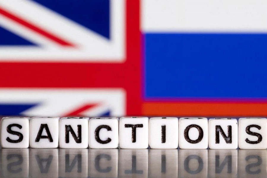 Plastic letters arranged to read "Sanctions" are placed in front the Union Jack and Russian flag colors in this illustration taken on February 28, 2022 — Reuters illustration
