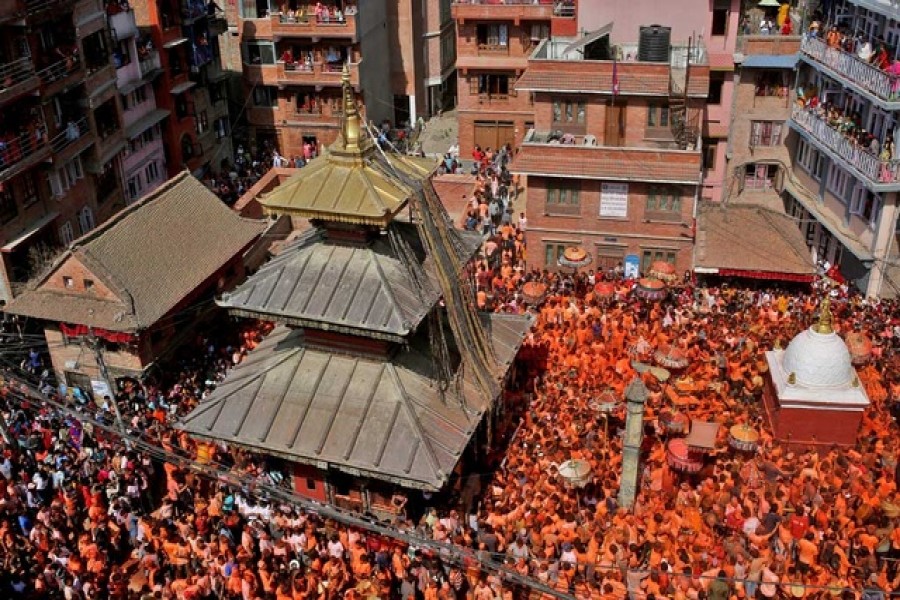 Devotees covered in vermilion powder carry chariots as they circle the Balkumari Temple during the "Sindoor Jatra" vermillion powder festival to welcome the arrival of spring and Nepali new year at Thimi, in Bhaktapur, Nepal, Apr 15, 2022. REUTERS/Monika Deupala