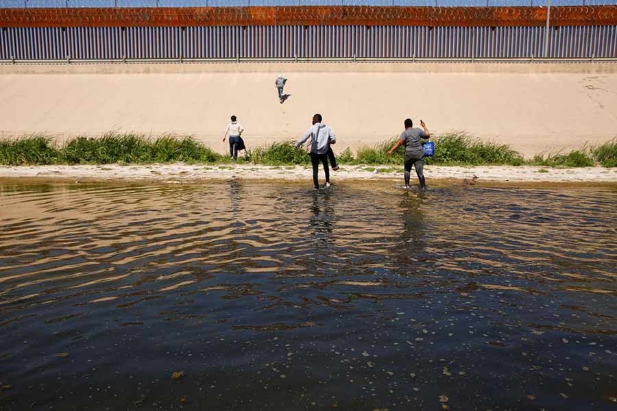 Asylum-seeking migrants walking out of the Rio Bravo River after crossing it to turn themselves into US Border Patrol agents to request asylum in El Paso of Texas in the US, as seen from Ciudad Juarez in Mexico on April 13 this year –Reuters file photo