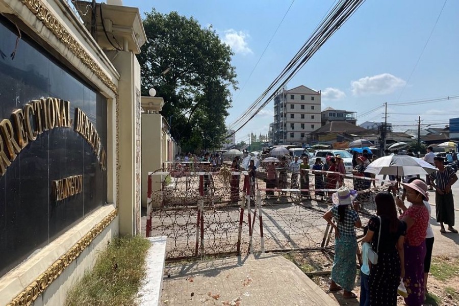 People wait at Insein prison in hopes of the release of their families members who were arrested due to the anti coup protests, in Yangon, Myanmar April 17, 2022. Assistance Association for Myanmar -Based Independent Journalists/Handout via REUTERS