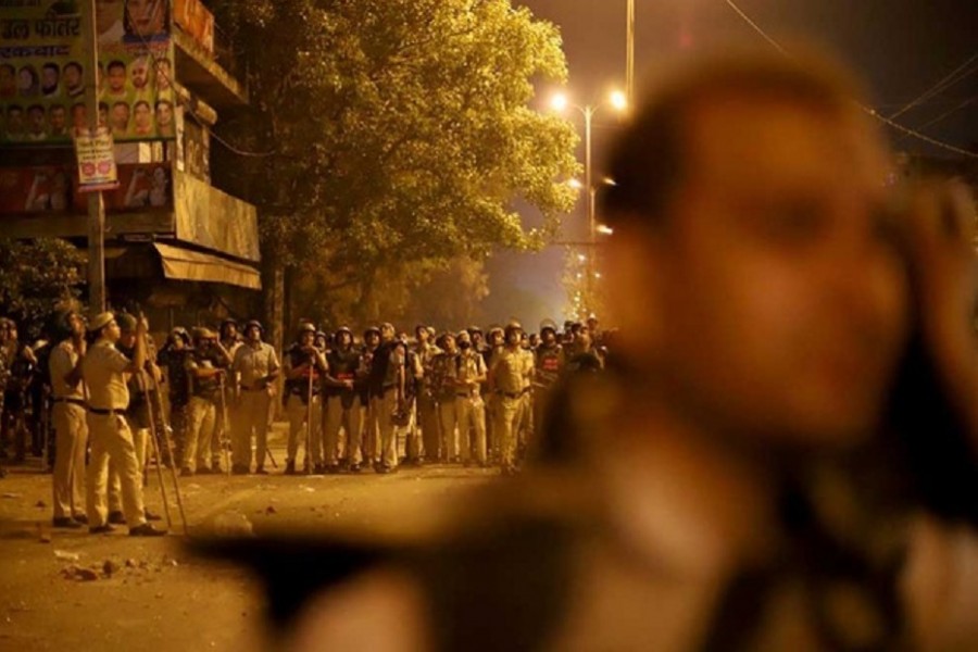 Police personnel stand guard after clashes broke out during a Hindu religious procession in Jahangirpuri area of New Delhi, India, Apr 16, 2022. Reuters