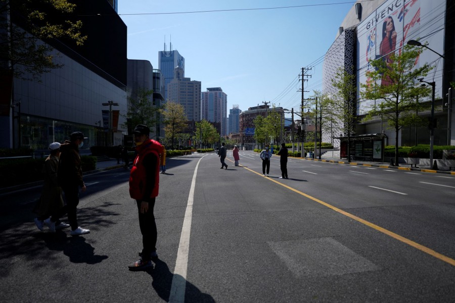 Residents stand on a street waiting for nucleic acid test during lockdown amid the coronavirus disease (Covid-19) pandemic, in Shanghai on China on April 17, 2022 — Reuters photo