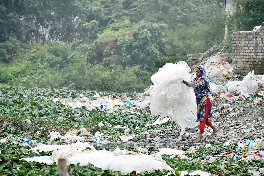 A woman carries plastic waste at a dumping site in Dhaka, Bangladesh on Jan. 8, 2020. —Xinhua Photo
