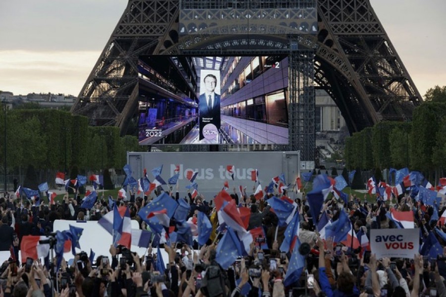 Supporters of French President Emmanuel Macron, candidate for his re-election, react after results were announced in the second round vote of the 2022 French presidential election, near Eiffel Tower, at the Champs de Mars in Paris, France April 24, 2022 – Reuters