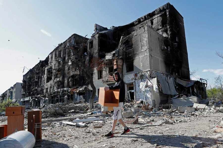 A local resident taking furniture out of an apartment building heavily damaged during the Ukraine-Russia conflict in the southern port city of Mariupol in Ukraine on Thursday –Reuters photo