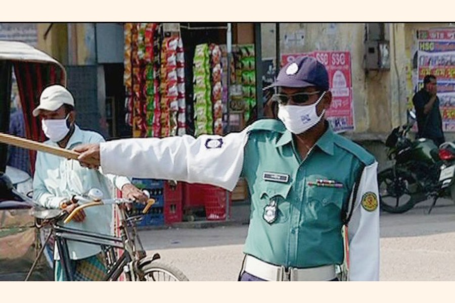 A traffic police constable on duty in Dhaka. 	—Collected Photo